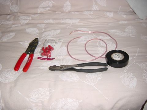 2003 Mazda 6 - Tools and supplies for electrical work are laid out on a patterned surface.