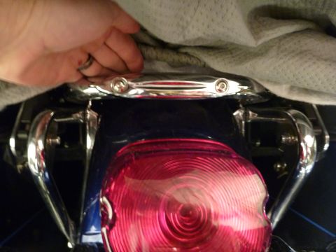 2007 Harley-Davidson Electra Glide Clsc - Close-up of the rear fender and taillight assembly on a 2007 Harley-Davidson Electra Glide Clsc, a chrome grab rail.