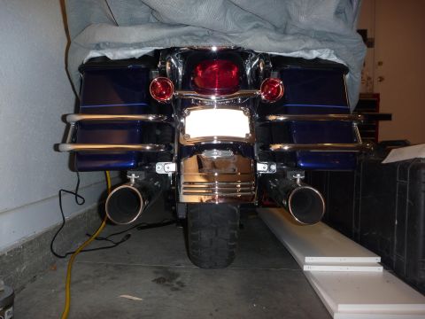 2007 Harley-Davidson Electra Glide Clsc - The rear of a blue motorcycle is shown, partially covered by a grey tarp.