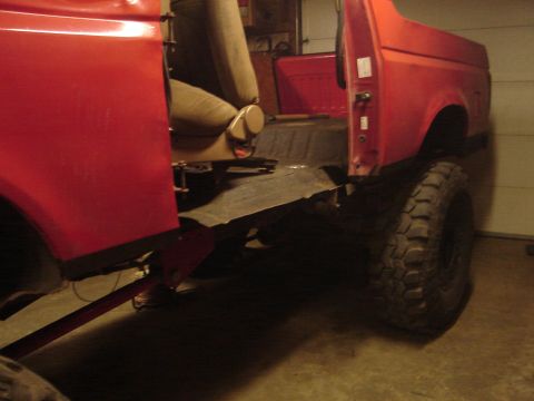1989 Ford Bronco - Interior view of a 1989 Ford Bronco, highlighting the tan seats and exposed metal flooring.