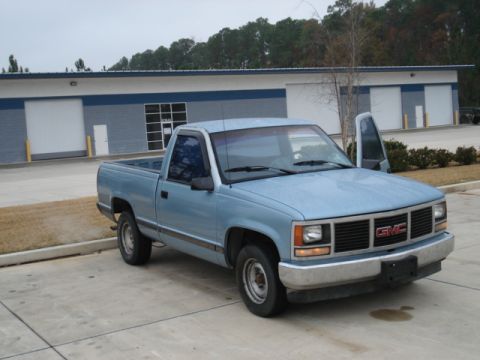 1979 Chevrolet C/K Pickup - This light blue GMC pickup truck is seen from a 3/4 front angle. The body style suggests a 1993 model year.