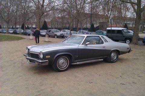 1991 Ford Crown Victoria - This two-tone coupe features prominent side pipes and a distinctive body style from the mid-1970s.
