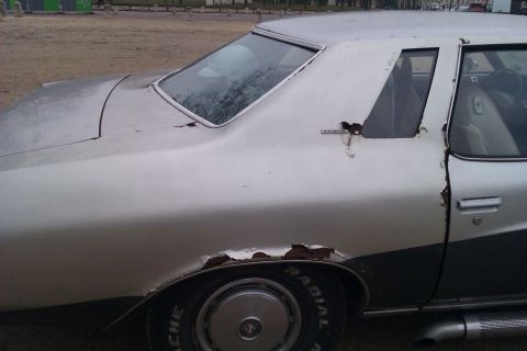 1991 Ford Crown Victoria - This car has extensive rust damage, particularly on the rear fender and door.