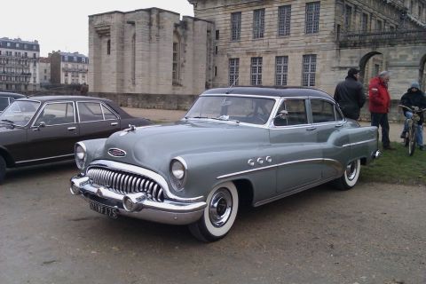 1991 Ford LTD Crown Victoria - A 1953 Buick Special sedan is parked outdoors with a building in the background.