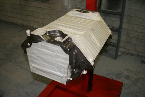 1973 Ford Ranchero - Engine block on a stand, wrapped for protection. The album claims it's a 1973 Ford Ranchero engine.