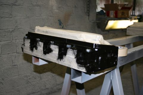 1973 Ford Ranchero - Engine block being prepped for painting, supported by sawhorses in a workshop setting.