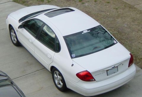 2003 Mazda 6 - A white sedan is parked on a concrete driveway, viewed from above.