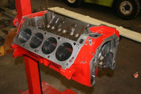1973 Ford Ranchero - Engine block on a stand, with visible cylinder bores and red paint.