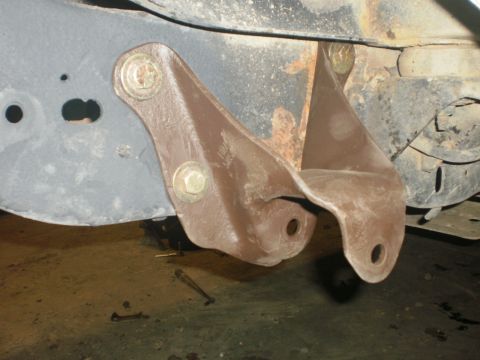 1995 Ford Bronco - Vehicle frame with a bolted-on rear axle bracket, showing signs of rust and wear.
