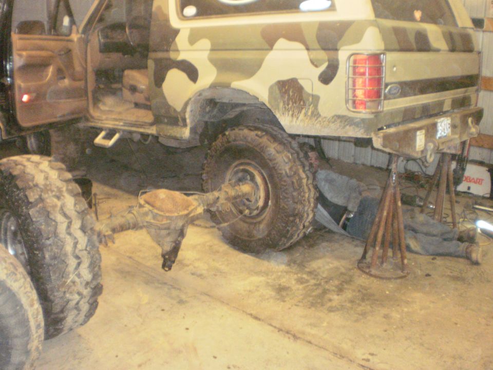 Camouflaged 1995 Ford Bronco rear axle removed for repair