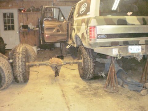 1995 Ford Bronco - Ford Bronco undergoing rear axle work in a garage.