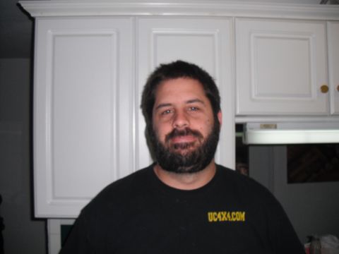 1991 Ford Bronco - A man with a beard smiles at the camera while wearing a black t-shirt with yellow text that reads UC4X4.COM.