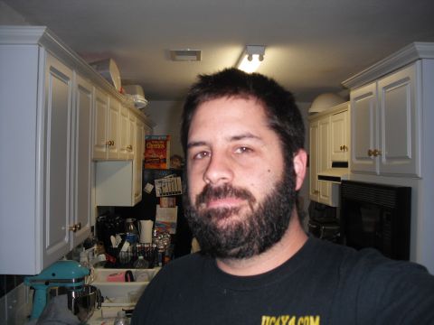 1991 Ford Bronco - A man with a beard poses for a photo in a kitchen setting, with cabinets and appliances visible in the background.