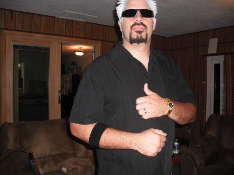 1991 Ford Bronco - A man in a black shirt and sunglasses poses indoors, giving a thumbs-up gesture.