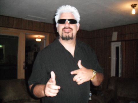 1991 Ford Bronco - A man dressed as Guy Fieri poses for a photo indoors.