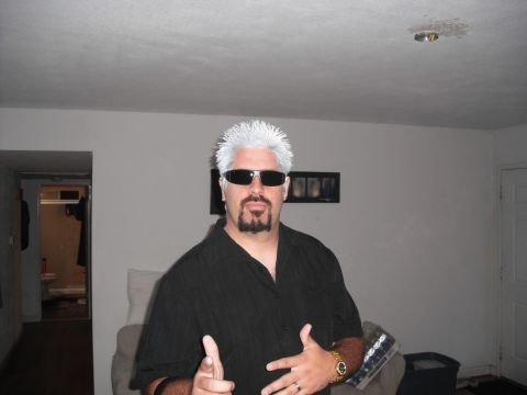 1991 Ford Bronco - A man dressed as Guy Fieri poses for a photo indoors, wearing sunglasses and a gold watch.