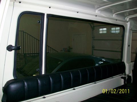 1986 Jeep Wagoneer - View from inside a vehicle shows a dark car parked in a garage, with a date stamp of 01/02/2011.