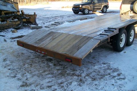 1963 Hummer H3 - A flatbed trailer and a bulldozer are parked in a snowy area, with a black SUV nearby.