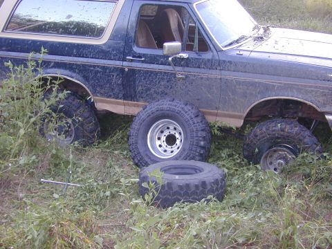 1996 Ford Bronco - This 1996 Ford Bronco appears to have multiple flat tires and is parked off-road.