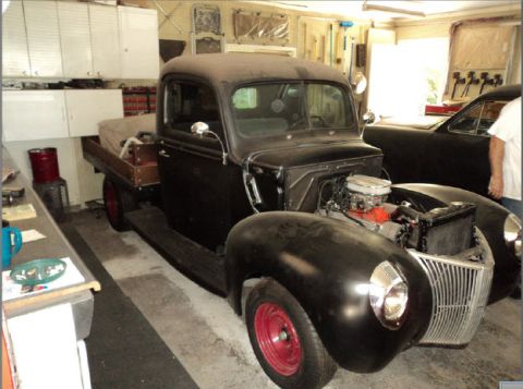 1941 Ford Pickup - This 1941 Ford Pickup is in a garage, with its engine visible and another vehicle beside it.