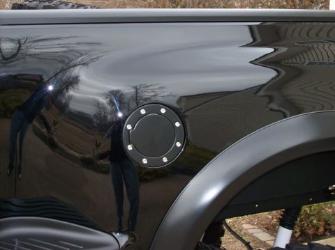 2000 Ford F-150 - Close-up of a black pickup truck's fuel door and fender flare.