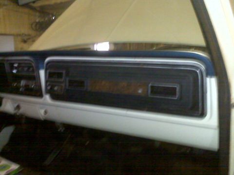 1973 Ford F-100 - Close-up view of the dashboard and center console area of a vehicle.