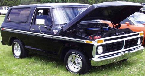 1979 Ford Bronco - This black Ford Bronco has its hood up, revealing the engine bay and chrome accents.