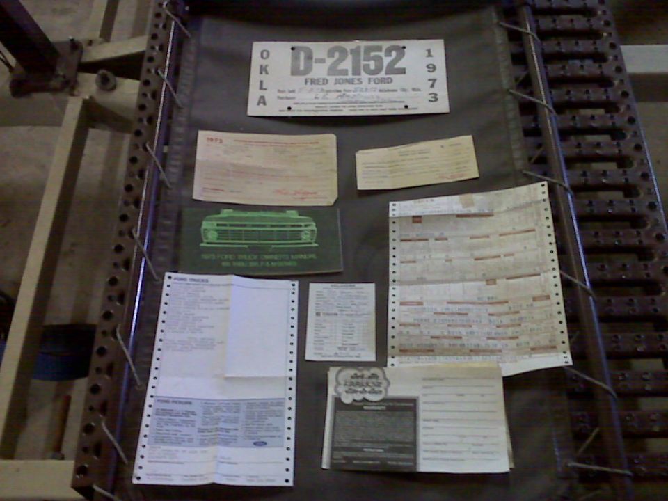License plate D-2152 Fred Jones Ford 1973, plus various papers including a brochure with a truck grille