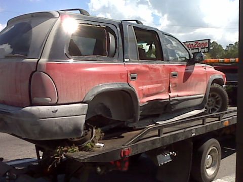 2002 Dodge Durango - This 2002 Dodge Durango is being towed on a flatbed truck after sustaining damage.