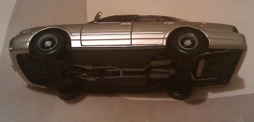 Silver sedan, upside down, showing undercarriage. 2000 Mercury Grand Marquis