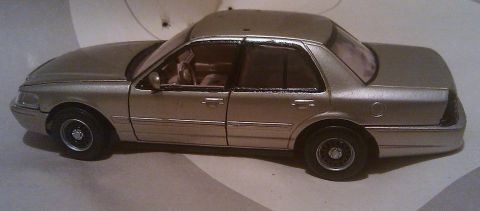 2000 Mercury Grand Marquis - Silver model car, possibly a 2000 Mercury Grand Marquis, shown from the side.