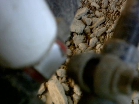 1995 Ford Bronco - Close-up of a white vehicle part with red trim, set against a backdrop of gravel and dirt. The Supermotors.net logo is visible in the corne…