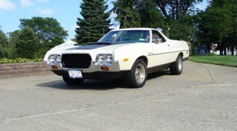 1972 Ford Ranchero - This pickup truck features a distinctive front grille and dual headlights, with a black accent on the hood.
