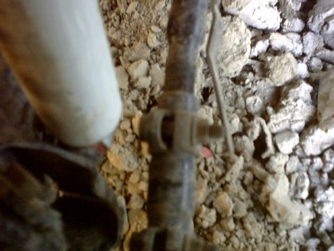 1995 Ford Bronco - A close-up view of a valve and pipe assembly, set against a backdrop of dirt and rocks.