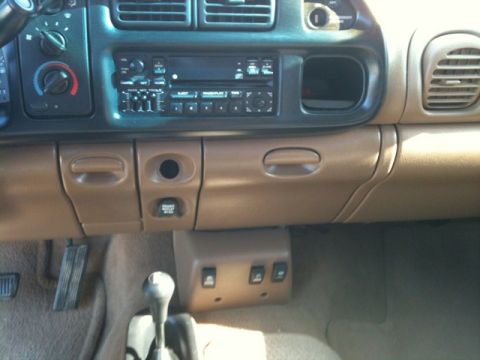 1966 Ford Bronco - Dashboard and center console of a vehicle, including the radio and gear shifter.