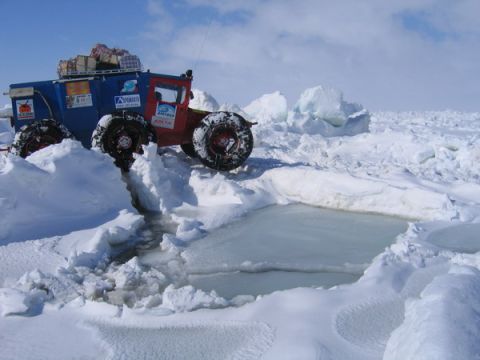 1987 Suzuki Samurai - Custom expedition vehicle navigating a challenging icy terrain under a bright sky.