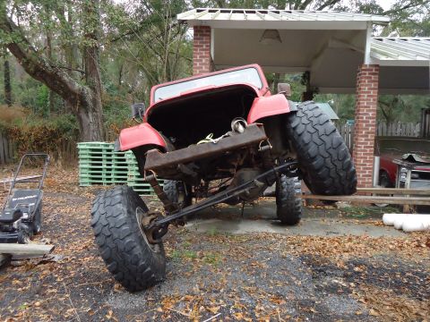 1985 Jeep CJ7 - This red Jeep appears to be a CJ model, likely from the 1980s, with significant modifications.