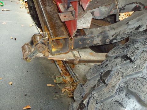 1985 Jeep CJ7 - The underside of a vehicle, focusing on the frame and suspension system with a large off-road tire visible.