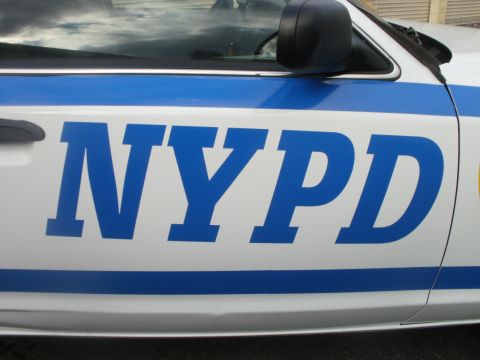 2002 Ford Crown Victoria - Close-up of the side door of an NYPD vehicle, showing the distinctive blue lettering.