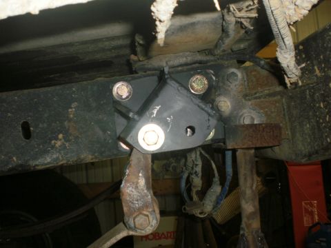 1995 Ford Bronco - Undercarriage view of a vehicle's frame with a newly installed bracket and suspension components.