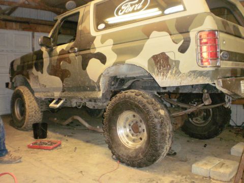 1995 Ford Bronco - This Ford Bronco features a camouflage paint scheme and appears to be undergoing modifications, possibly related to its rear axle.