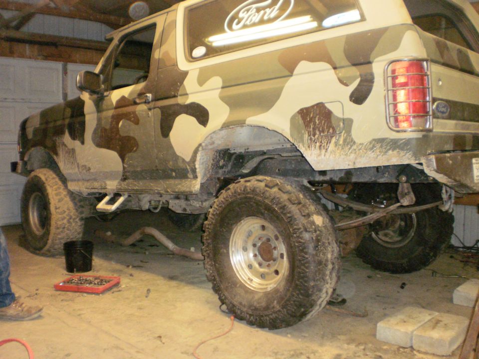 Camouflaged Ford Bronco rear view, showing suspension and large tires
