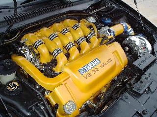 1997 Ford Taurus - Engine bay detail showing a Yamaha V6 32 valve engine with custom yellow paint.