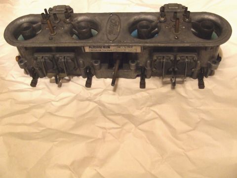 1973 Ford Mustang - A Ford Autolite inline carburetor is shown from the front, resting on crumpled paper.