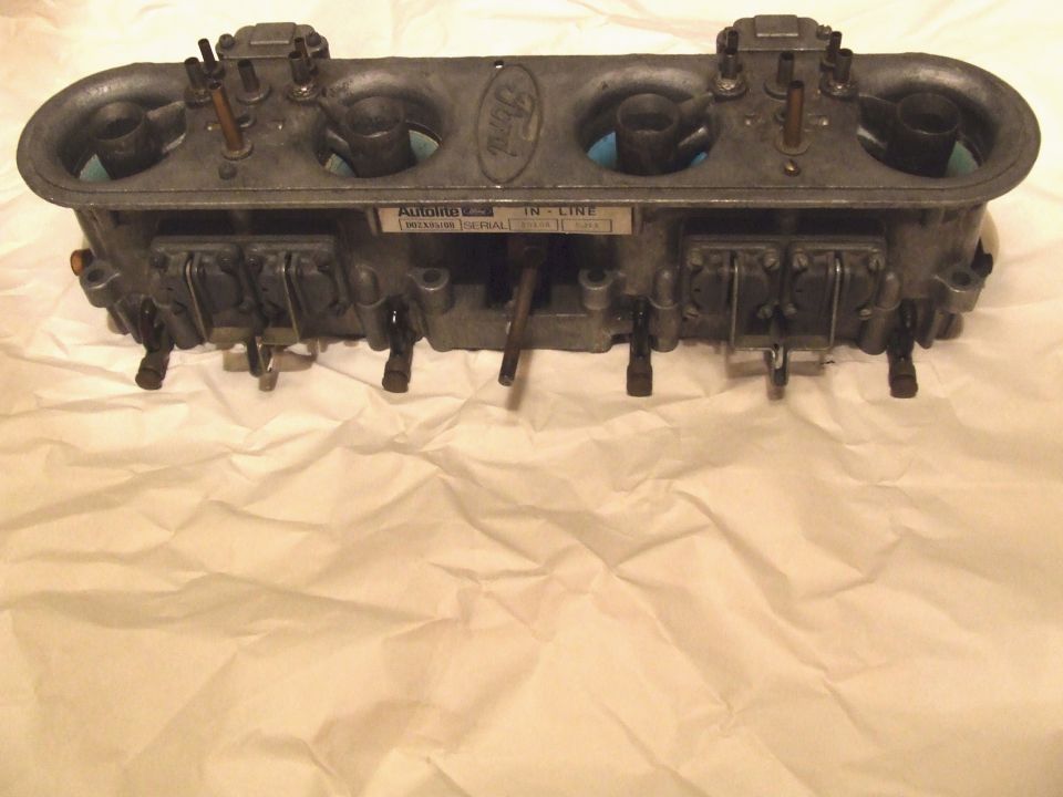 Ford Autolite inline carburetor with four barrels and a Ford oval logo