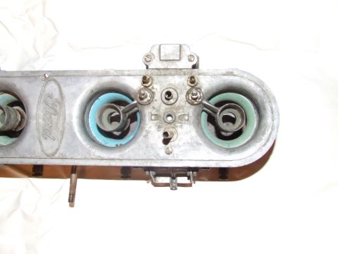 1973 Ford Mustang - This Ford carburetor features a prominent oval logo and two distinct gasket colors, indicating a specific engine component.