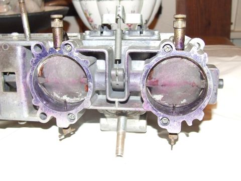 1973 Ford Mustang - This is a close-up view of a dual-barrel carburetor, showing its internal components and purple markings.