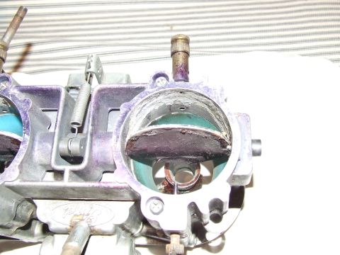 1973 Ford Mustang - A close-up view of a Ford carburetor, showing its internal components and purple exterior accents.