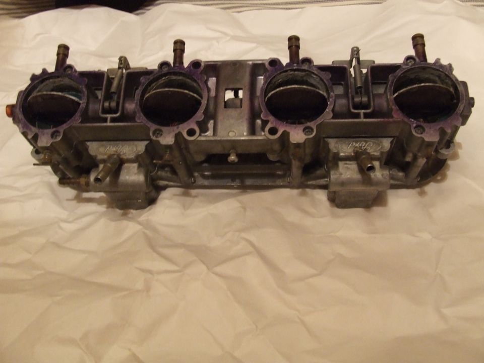 Quadrajet carburetor with four barrels, purple markings on intake flanges