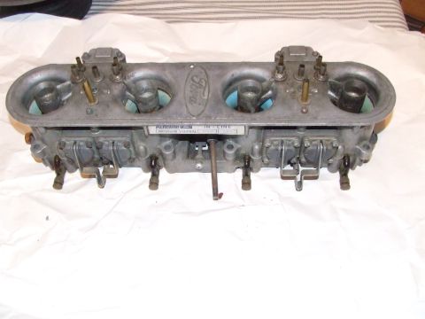 1973 Ford Mustang - This Ford dual carburetor assembly features the prominent "Ford" oval logo and "AUTOLITE" branding on a metal plate.